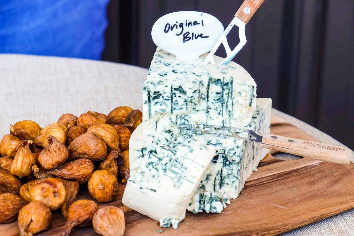 A wedge of blue cheese on a cutting board