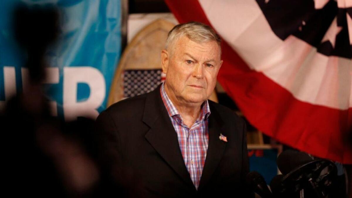 Rep. Dana Rohrabacher addresses reporters and his supporters at an election night party in Costa Mesa on Nov. 6.