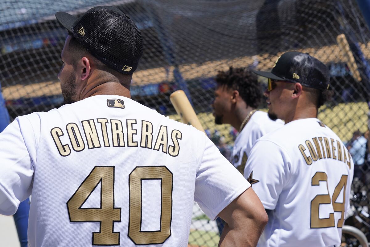 National League's catcher Willson Contreras stands next to his brother National League designated hitter William Contreras.