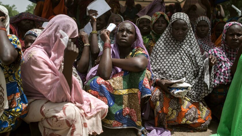 Women wait for food to be distributed in the town of Banki in northeastern Nigeria.