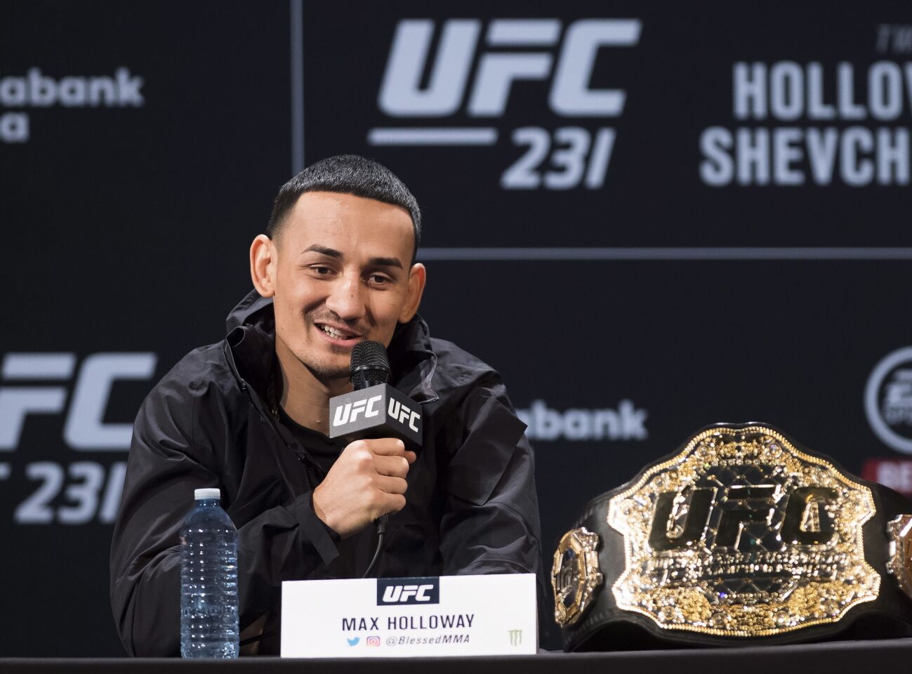 UFC featherweight champion Max Holloway speaks at a press conference, Wednesday, Dec. 5, 2018 in Toronto. UFC 231 takes place on Saturday, Dec. 8, 2018. (Nathan Denette/The Canadian Press via AP)