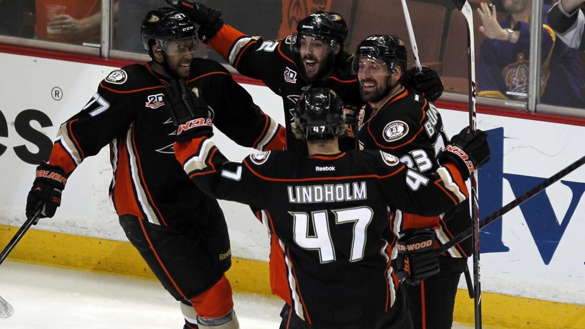 Ducks teammates celebrate a goal by Devante Smith-Pelly, far left, during the second period of the team's 4-3 win over the Kings in Game 5 of the Western Conference semifinals at Honda Center on Monday.