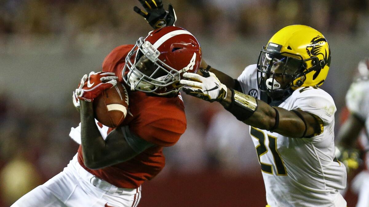 Alabama wide receiver Jerry Jeudy (4) catches a pass over Missouri defensive back Christian Holmes (21) during the second half on Oct. 13 in Tuscaloosa, Ala.