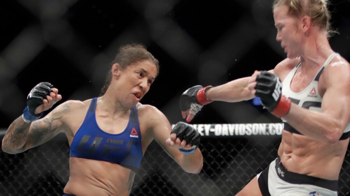 Germaine de Randamie, left, fights Holly Holm during a women's featherweight bout at UFC 208 on Feb. 12.