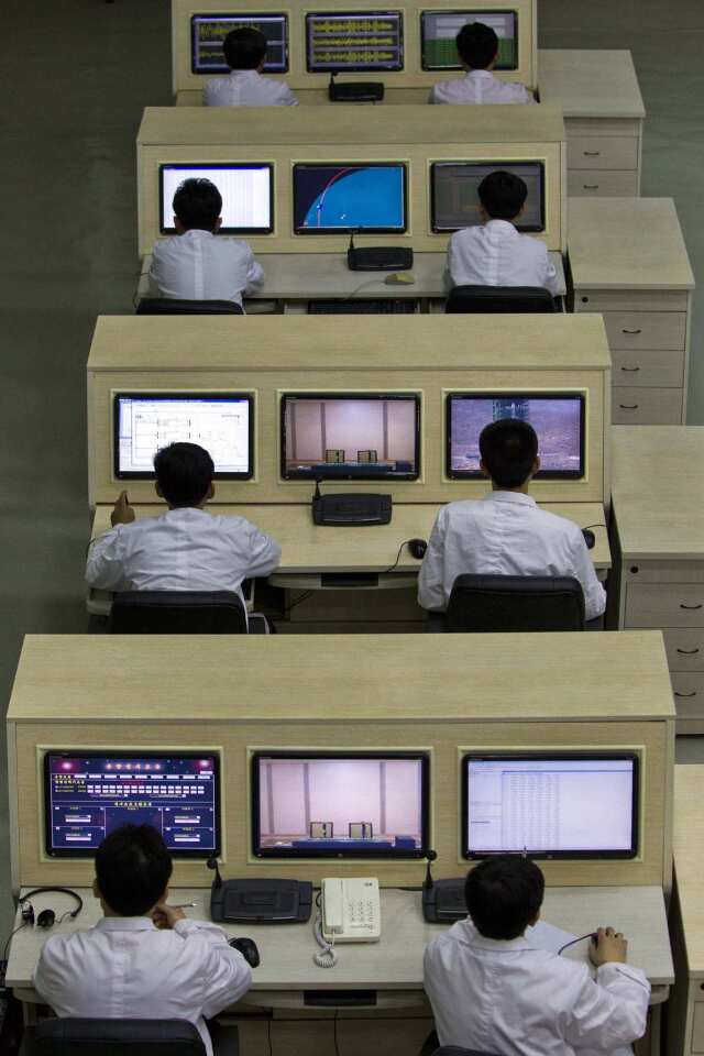 North Korean technicians man computer terminals at North Korea's space agency's General Launch Command Center on the outskirts of Pyongyang.