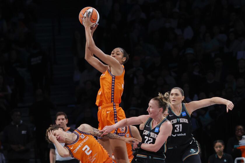 New York Liberty guard Courtney Vandersloot, second from right, and center, Stefanie Dolson, right, defend against Connecticut Sun guard Natisha Hiedeman (2) and forward Olivia Nelson-Ododa, top, during the first quarter of a WNBA basketball game, Sunday, Sept 24, 2023, in New York. (AP Photo/Eduardo Munoz Alvarez)