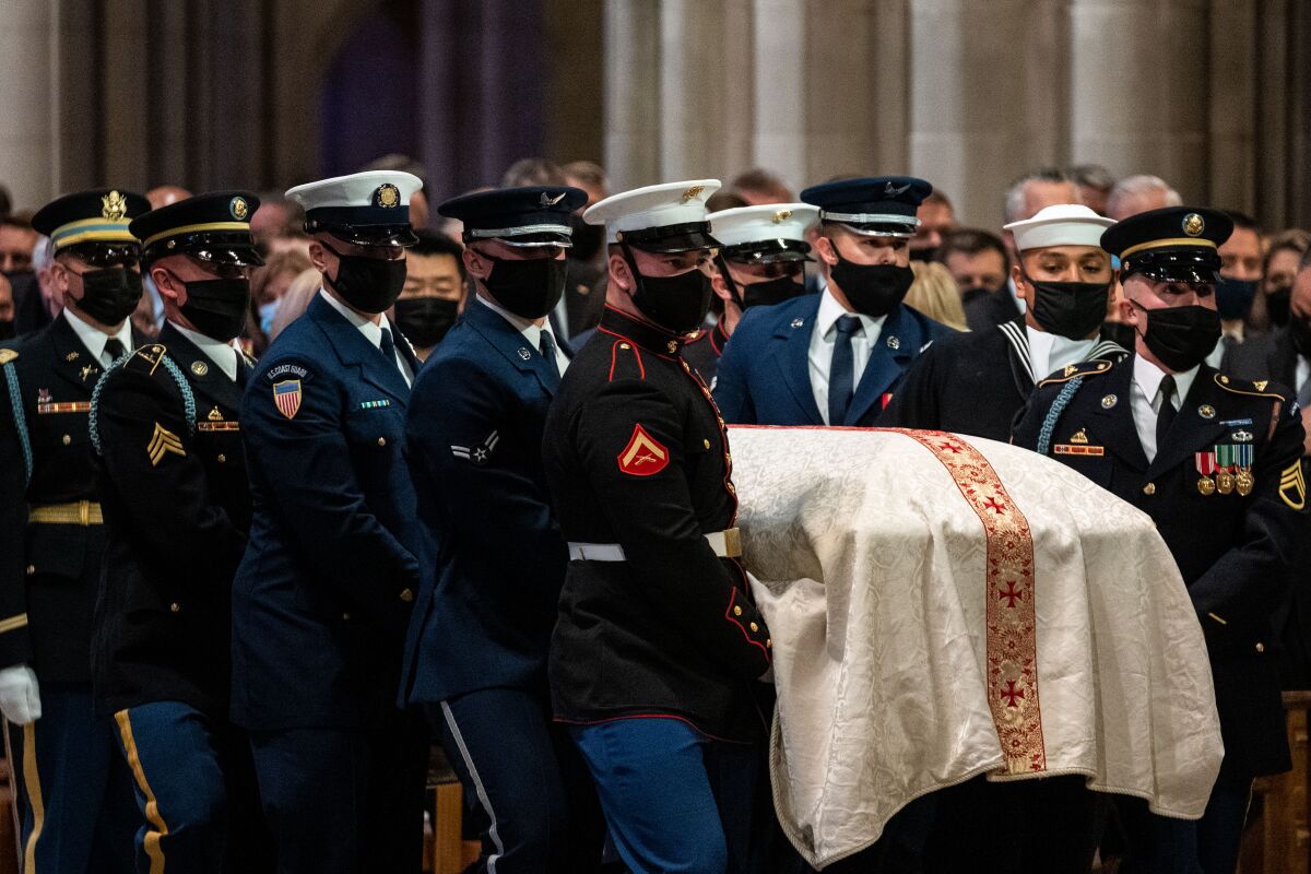 Military personnel carry Bob Dole's casket at Washington National Cathedral.