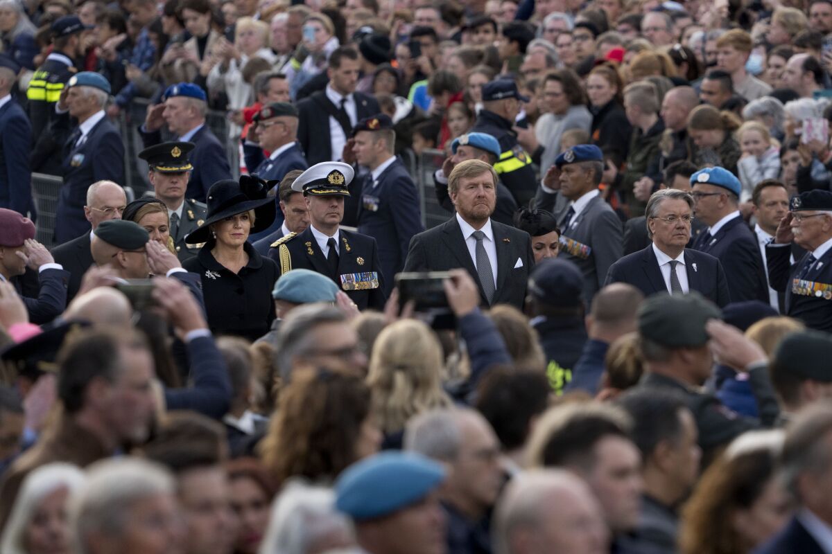 Dutch King Willem-Alexander and Queen Maxima, center arrive for the Remembrance Day ceremony at the national monument on Dam square in Amsterdam, Netherlands, Wednesday, May 4, 2022, commemorating civilians and members of the armed forces who have died in wars and peacekeeping missions since the start of the Second World War. (AP Photo/Peter Dejong)