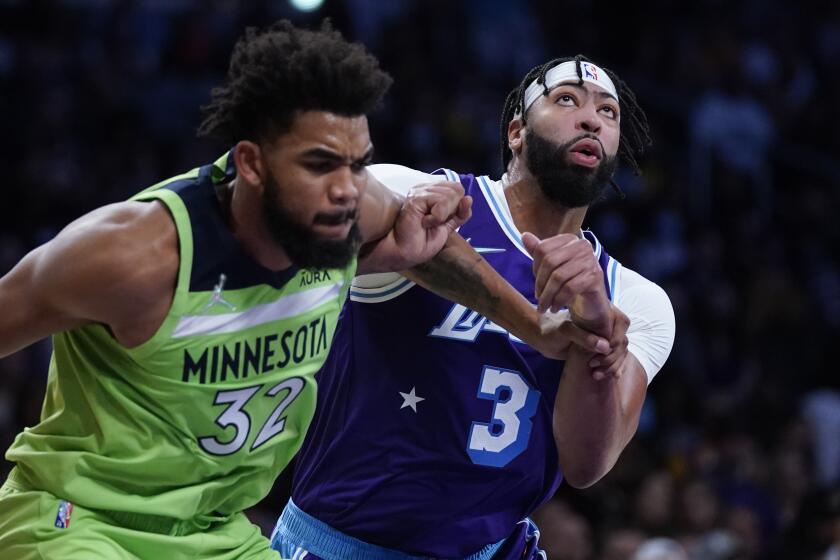Los Angeles Lakers' Anthony Davis, right, and Minnesota Timberwolves' Karl-Anthony Towns.