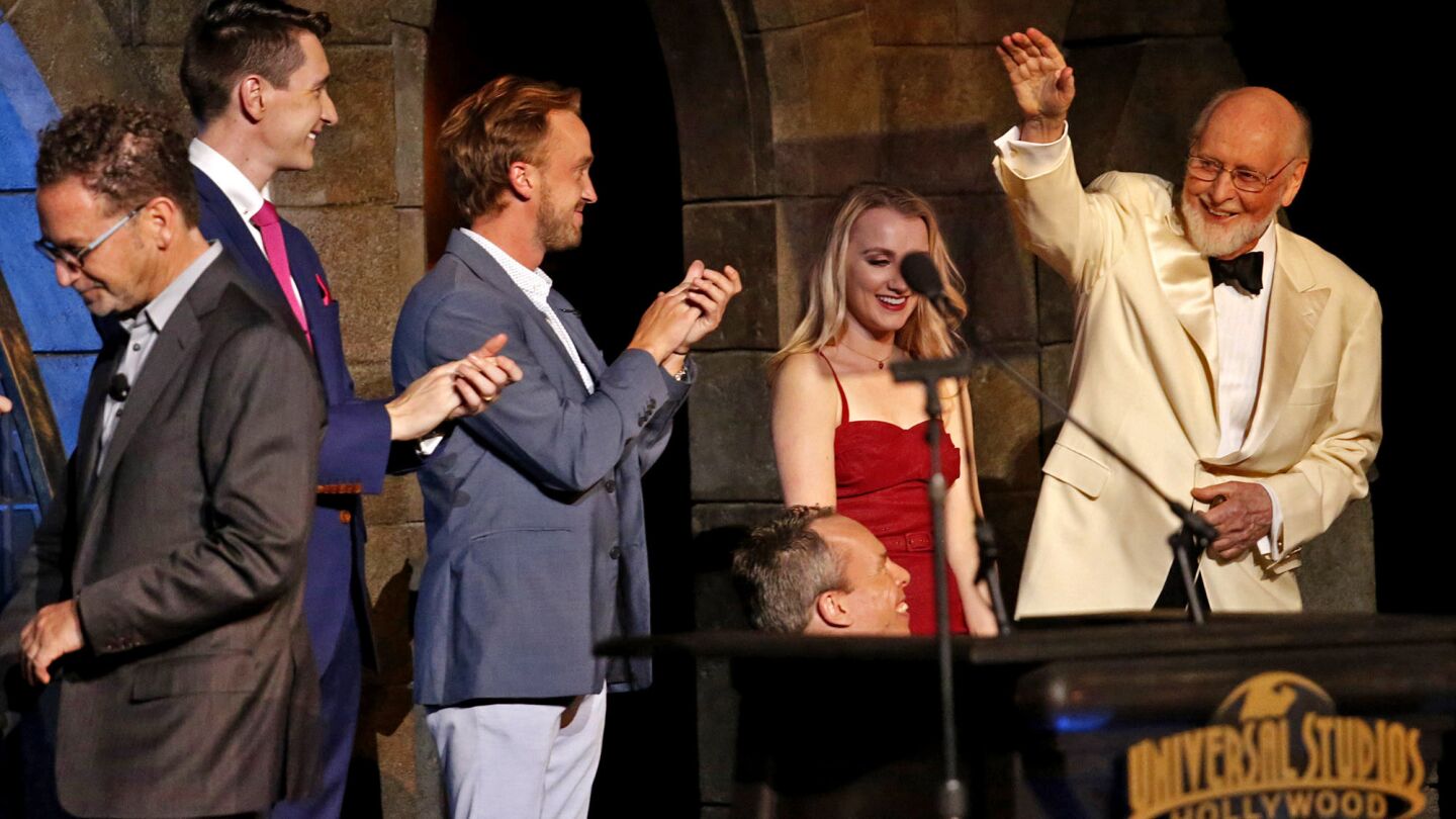 Composer John Williams, right, at the VIP opening with Harry Potter actors Evanna Lynch, Warwick Davis, Tom Felton and Oliver Phelps, from right, and Universal Studios Hollywood President Larry Kurzweil, left.