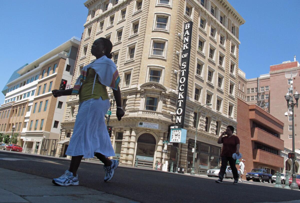 Pedestrians cross a street in Stockton in 2012.