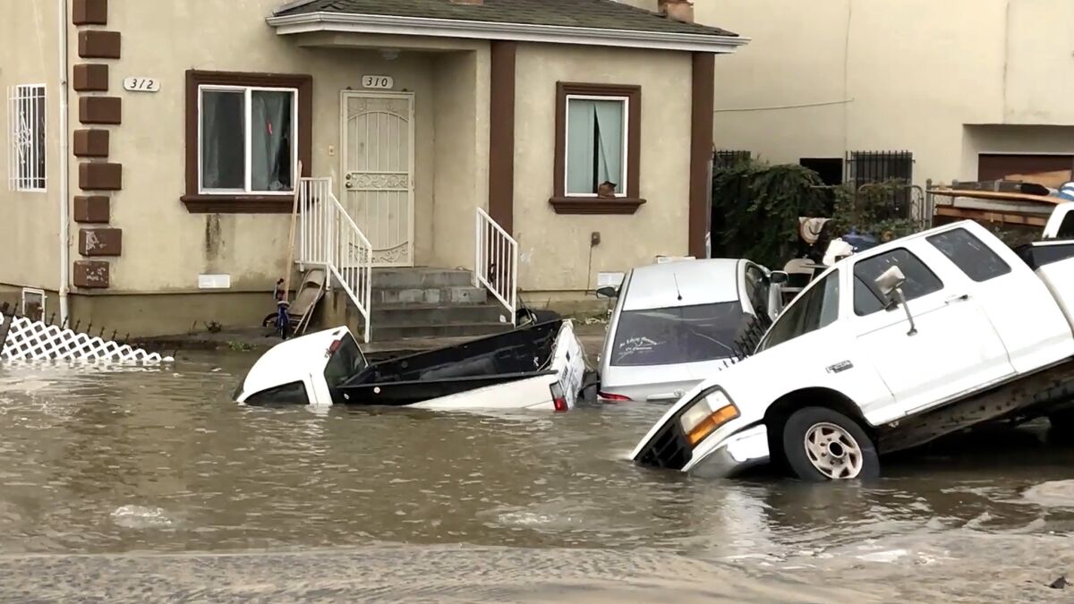 Several vehicles are submerged after a water main break in South Los Angeles.