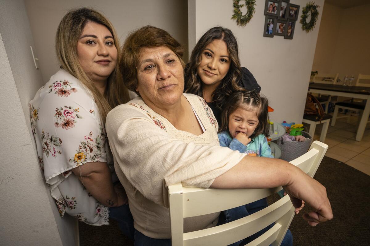 Family members gather around their mother