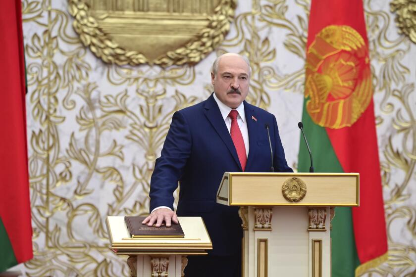 Belarusian President Alexander Lukashenko takes his oath of office during his inauguration ceremony at the Palace of the Independence in Minsk, Belarus, Wednesday, Sept. 23, 2020. Lukashenko of Belarus has assumed his sixth term of office in an inauguration ceremony that wasn't announced in advance. State news agency BelTA reports that the ceremony will take place with several hundred top government official present. (Andrei Stasevich/Pool Photo via AP)
