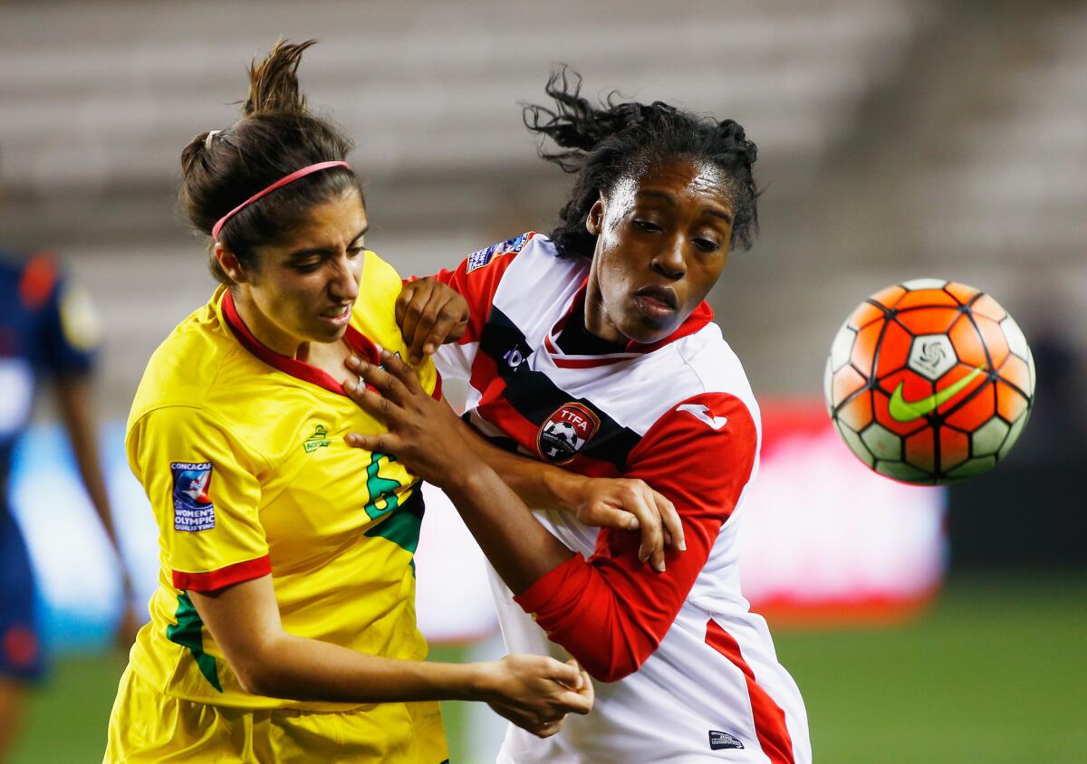Guyana's Leah Ramalho (6) battles for the ball with Jo Marie Lewis (16) of Trinidad & Tobago during the 2016 CONCACAF Women's Olympic Qualifying in Houston, Texas.