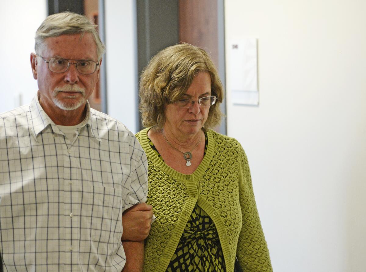 Robert and Arlene Holmes, parents of Aurora theater gunman James Holmes, walk from the courtroom at the Arapahoe County Justice Center last year. On Tuesday, Robert Holmes testified in the hope that his son's life would be spared.