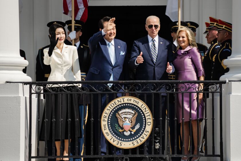 WASHINGTON, DC - APRIL 26: First Lady Kim Keon Hee of South Korea, South Korean President Yoon Suk Yeol, President Joe Biden and First Lady Dr. Jill Biden wave from a balcony of the White House during an official state visit at the South Lawn of the White House on Wednesday, April 26, 2023 in Washington, DC. (Kent Nishimura / Los Angeles Times)