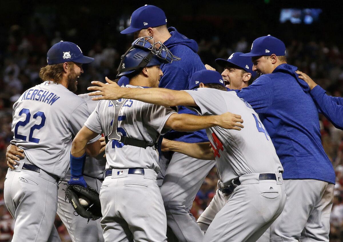 The Los Angeles Dodgers celebrate after game 3 of baseball's National League Division Series against the Arizona Diamondbacks, Monday, Oct. 9, 2017, in Phoenix. The Dodgers won 3-1 to advance to the National League Championship Series.