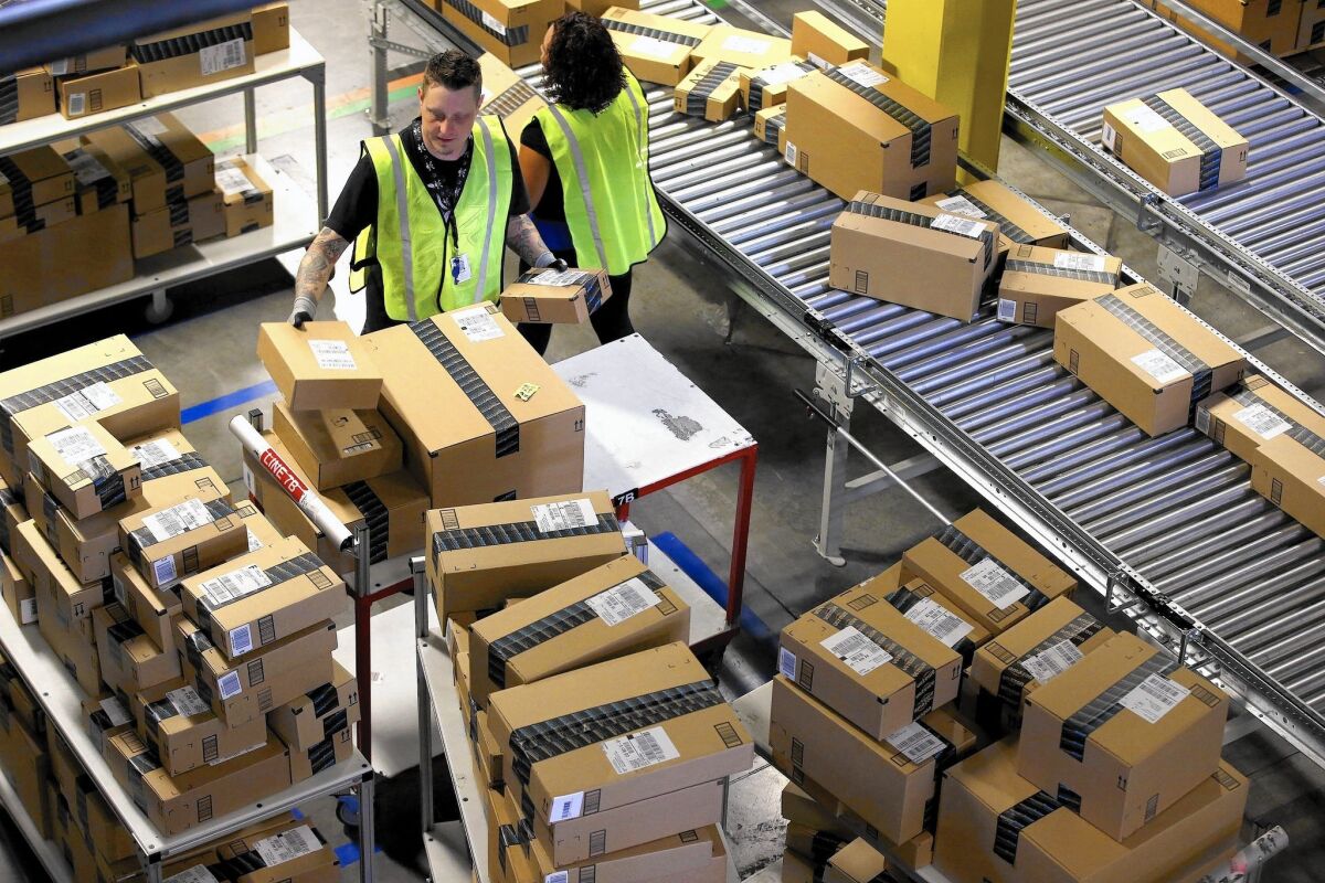 Employees organize outbound packages at Amazon's San Bernardino fulfillment center in 2013.