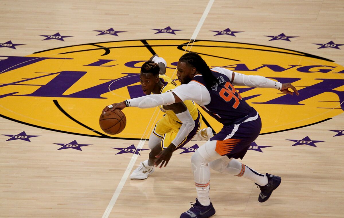 Lakers guard Dennis Schroder tries to steal the ball from Suns forward Jae Crowder.