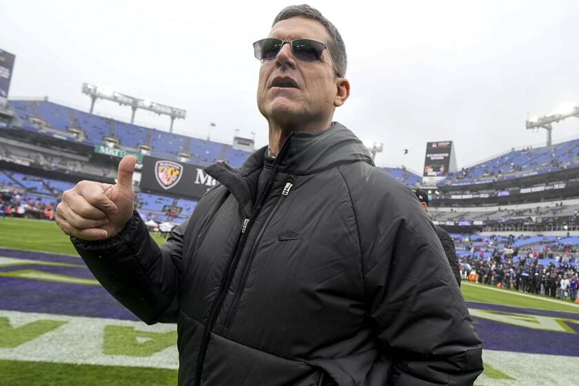 Los Angeles Chargers new head coach Jim Harbaugh walks on the field before an AFC Championship NFL football game