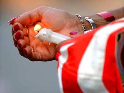 A woman lights a candle at Union Square in remembrance of the World Trade Center attacks.