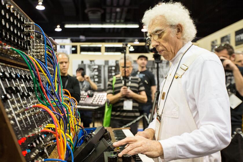 ANAHEIM, CA - JANUARY 25: Producer/musician Malcolm Cecil demonstrates a Moog synthesizer at The NAMM Show on January 25, 2015 in Anaheim, California. (Photo by Daniel Knighton/WireImage)
