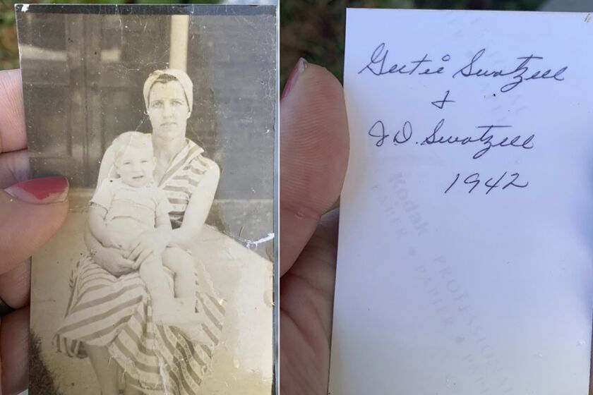 This photo combo shows Katie Posten holding the front and back of a photograph she found stuck to her car's windshield on Saturday, Dec. 11, 2021 in New Albany, Ind. The photo is from a tornado-damaged home in Kentucky that landed almost 130 miles away in Indiana. (Katie Posten via AP).