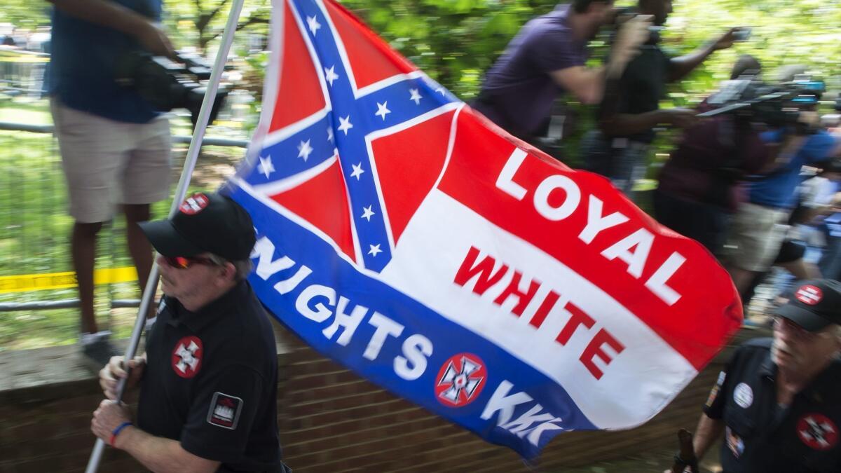Hate groups like the Ku Klux Klan, shown at their July 8, 2017, rally in Charlottesville, Va., will be able to meet in public libraries.