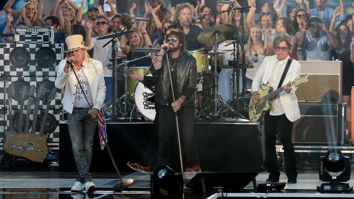 Cheap Trick and Billy Ray Cyrus perform during Wednesday's CMT Music Awards.