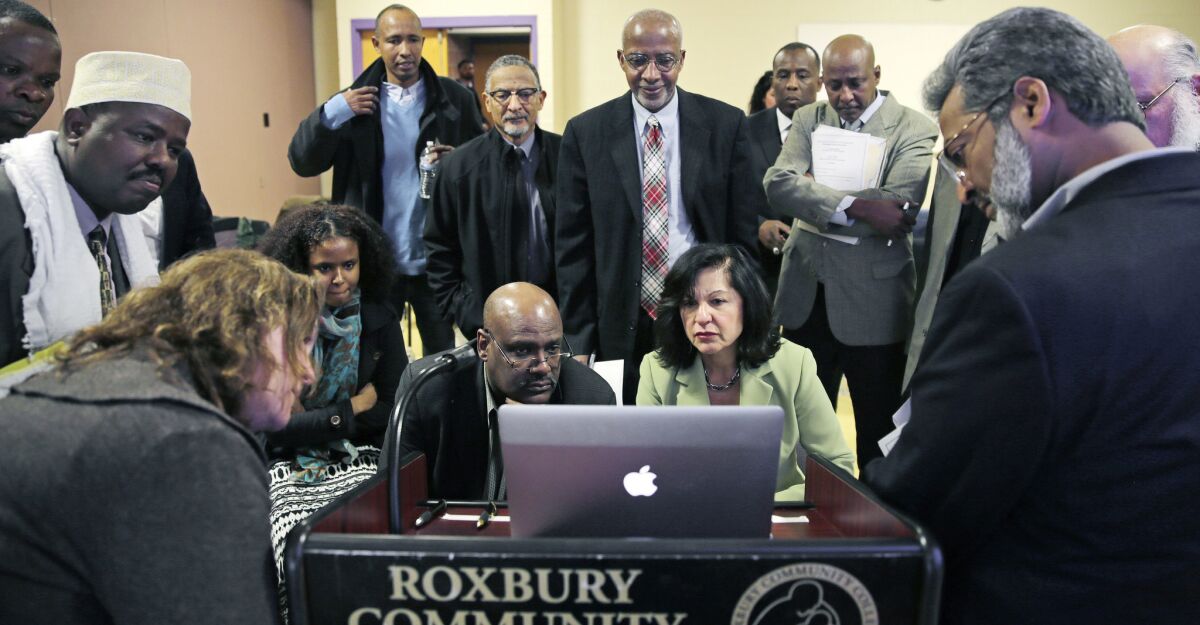 In this March 2015 photo, Muslim, Christian, minority and government leaders watch a video as part of a federal pilot program called Countering Violent Extremism, at Roxbury Community College in Boston.