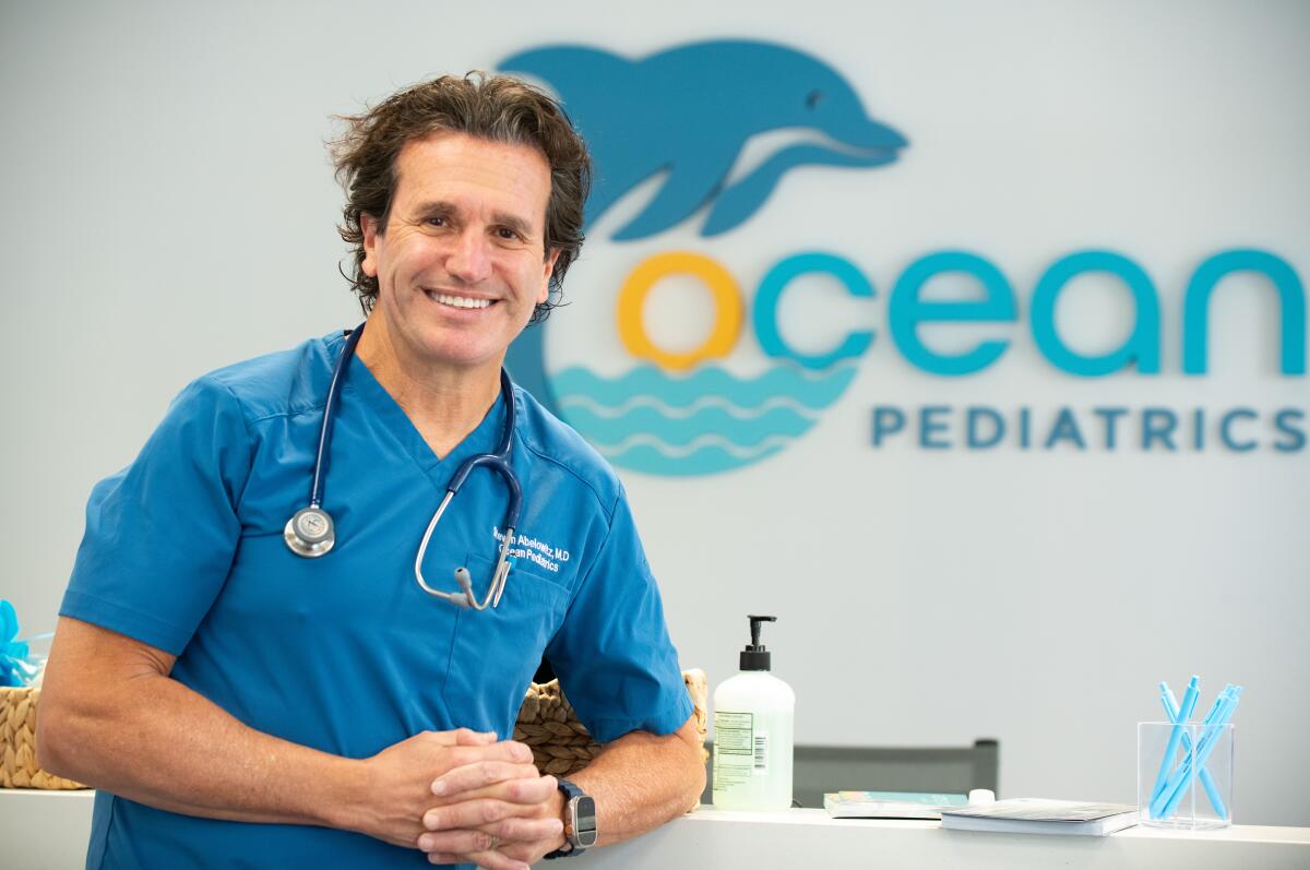 Dr. Steve Abelowitz stands near a desk in the Costa Mesa location of Ocean Pediatrics.