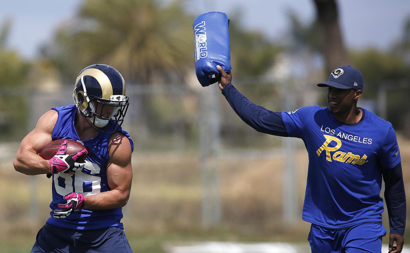 Rams wide receiver Nelson Spruce makes a catch with a coach nearby trying to disloge the ball during the rookie mini-camp on Saturday in Oxnard.