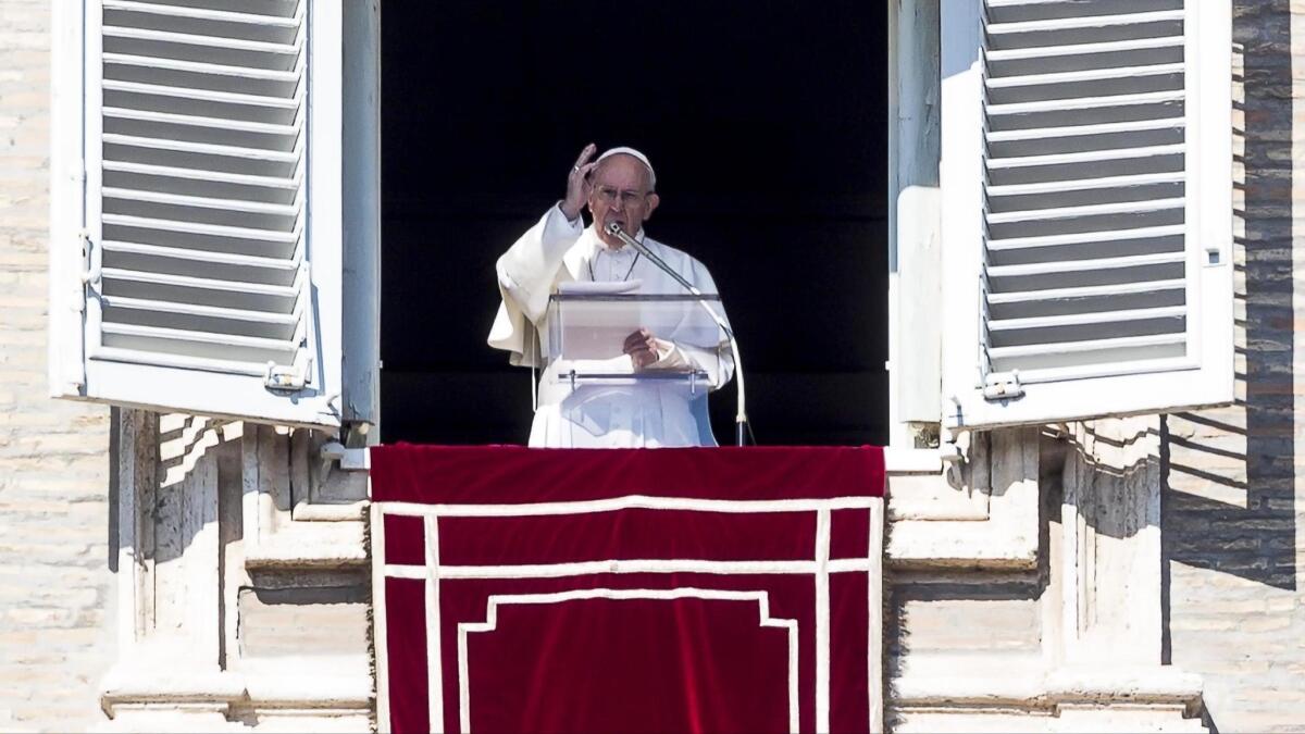 Pope Francis celebrates the traditional Sunday Angelus prayer for the faithful in St. Peter's Square from a window at the Apostolic Palace in Vatican City on Feb. 17.