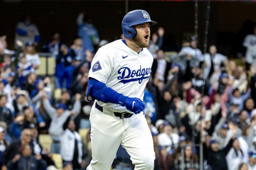 LOS ANGELES, CA - MARCH 31, 2024: Los Angeles Dodgers third baseman Max Muncy (13) leaps.