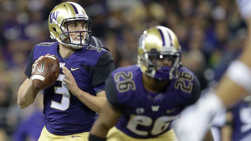 Washington quarterback Jake Browning looks to pass behind running back Salvon Ahmed during the second against BYU on Saturday in Seattle.
