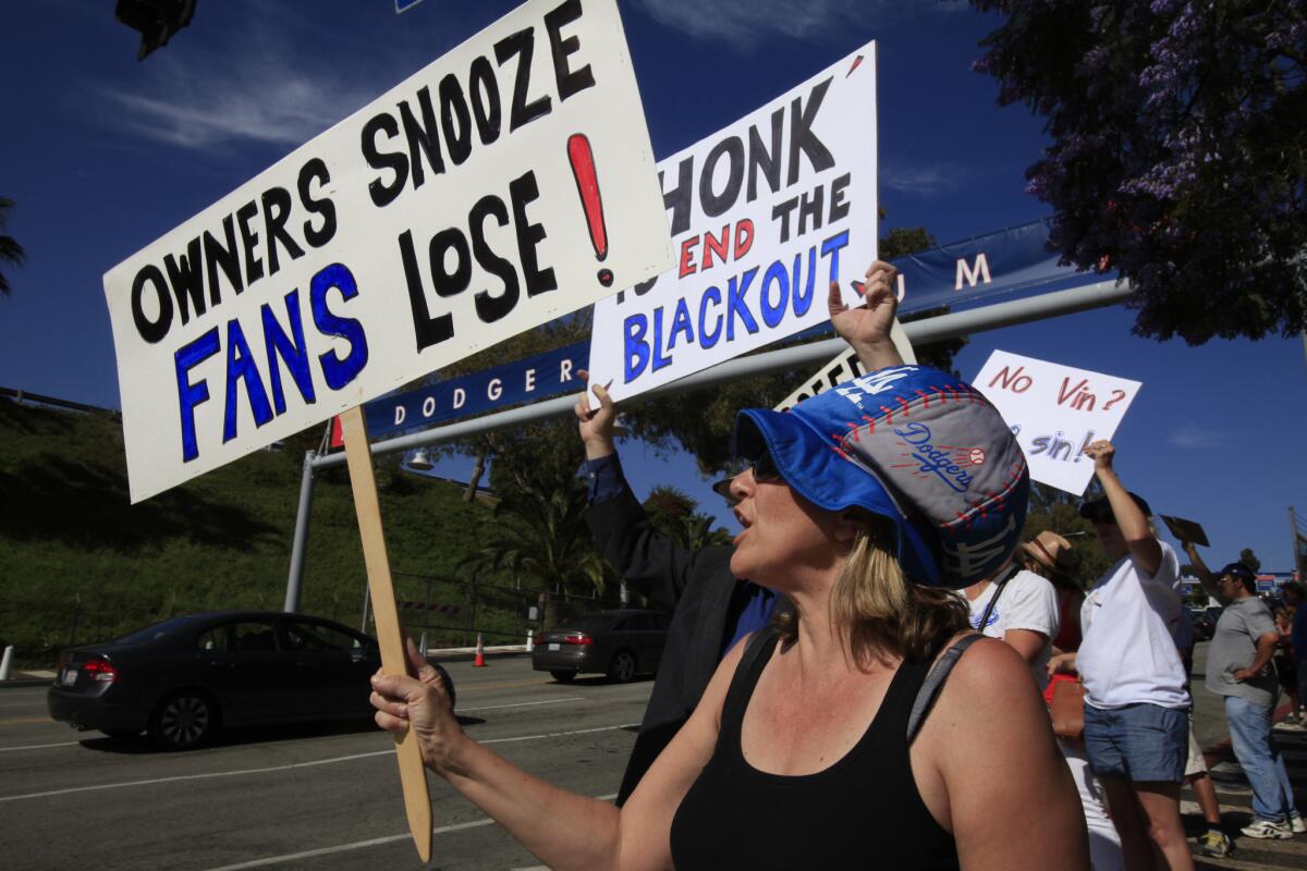 Beth Rigazio, of Los Angeles, and approximately 25 other people protest the Time Warner Cable TV deal, which did not allow for a majority of people in Southern California to watch the Dodgers games on TV last season.