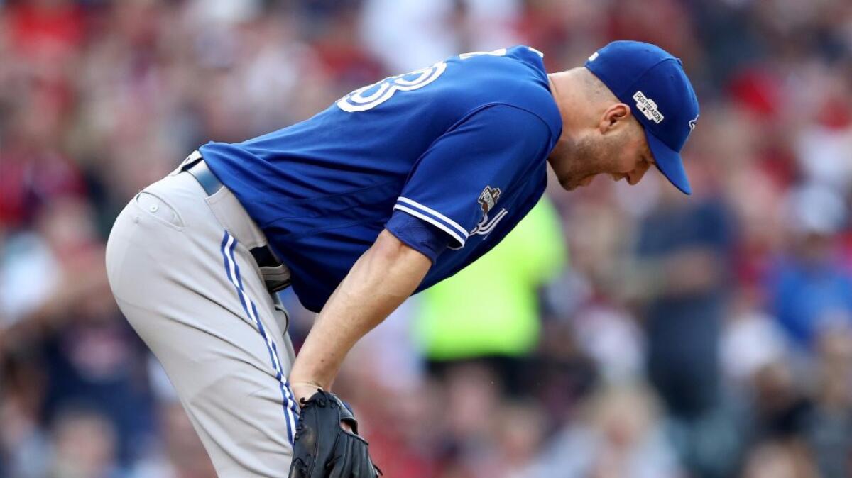Toronto pitcher J.A. Happ reacts during the fifth inning of the Blue Jays' 2-1 loss to Cleveland in Game 2 of the American League Championship Series.