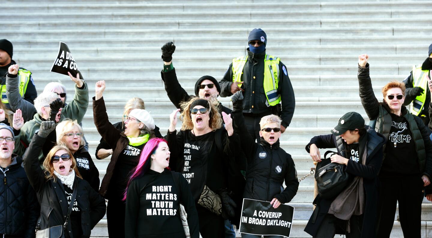 Several dozen protesters defy Capitol Police warnings of illegal protests on the Capitol steps at the start of the Senate impeachment trial of President Trump in Washington, D.C., on Wednesday.