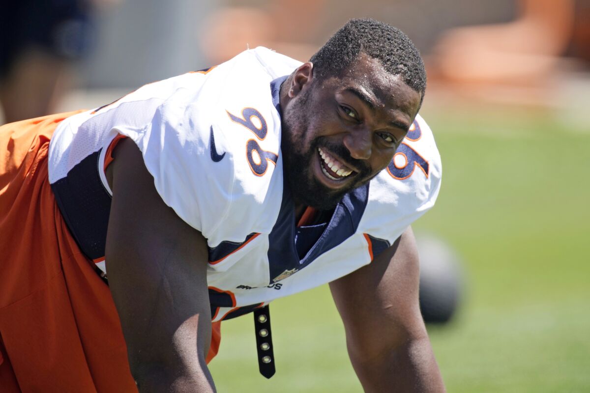 FILE- Denver Broncos defensive end Shelby Harris jokes with teammates as they take part in drills during NFL football training practice at the team's headquarters on Aug. 25, 2021, in Englewood, Colo. For both Shelby Harris and Noah Fant, their unexpected offseason move joining the Seattle Seahawks feels a bit like an eventuality finally coming true. (AP Photo/David Zalubowski, File)