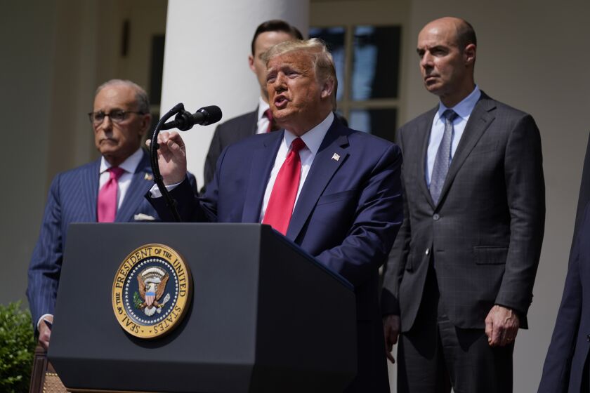 President Donald Trump speaks during a news conference in the Rose Garden of the White House, Friday, June 5, 2020, in Washington. White House chief economic adviser Larry Kudlow, left, and Labor Secretary Eugene Scalia, top right listen. (AP Photo/Evan Vucci)
