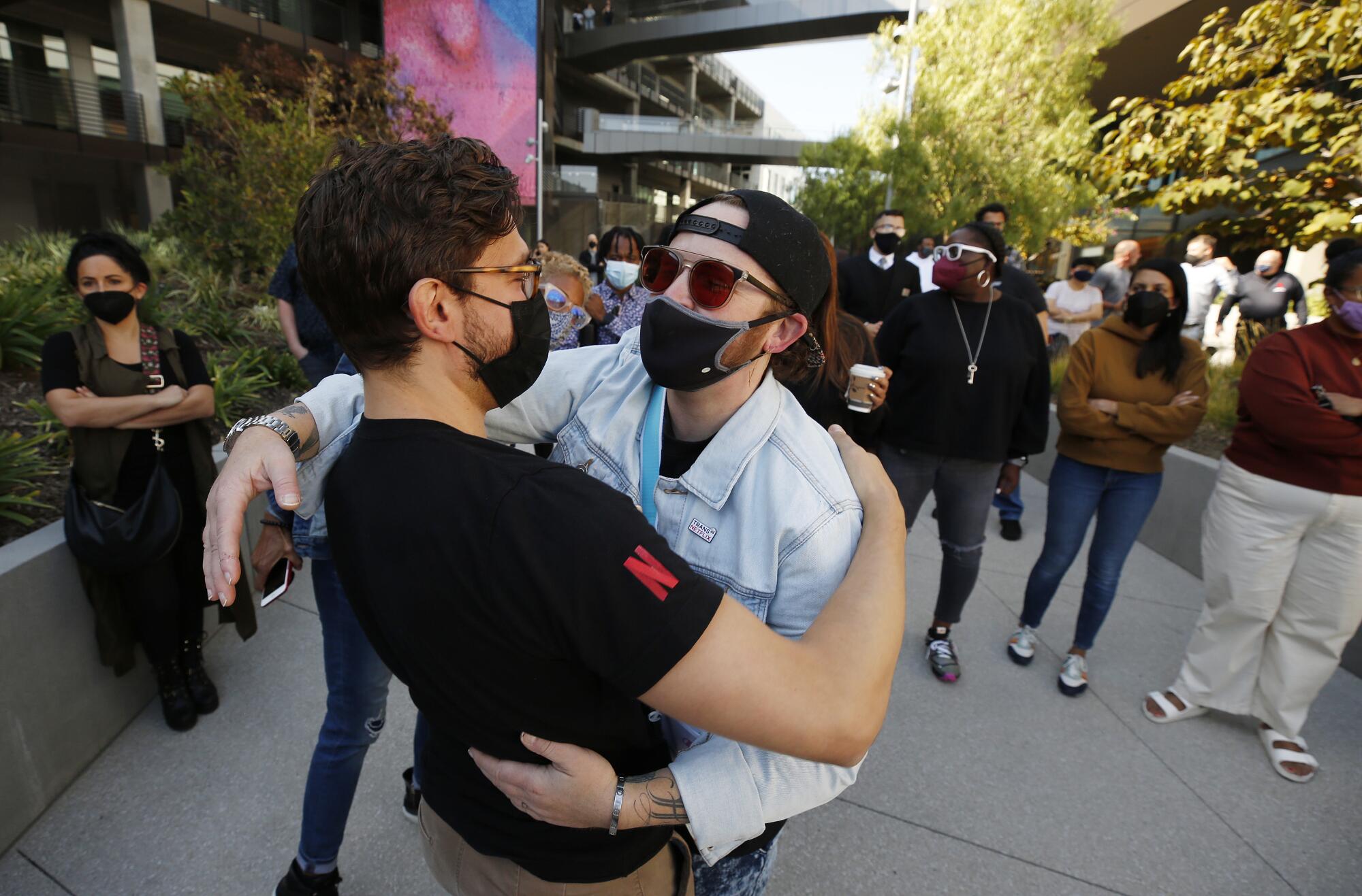 Netflix employees hug during protest in Hollywood on Wednesday.