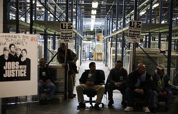 Workers stage a sit-in Monday at the now-shuttered Republic Windows & Doors plant on Chicago's Goose Island. Workers were fired Friday but have refused to leave until the company relents and gives them the severance and vacation pay that theyve already earned.