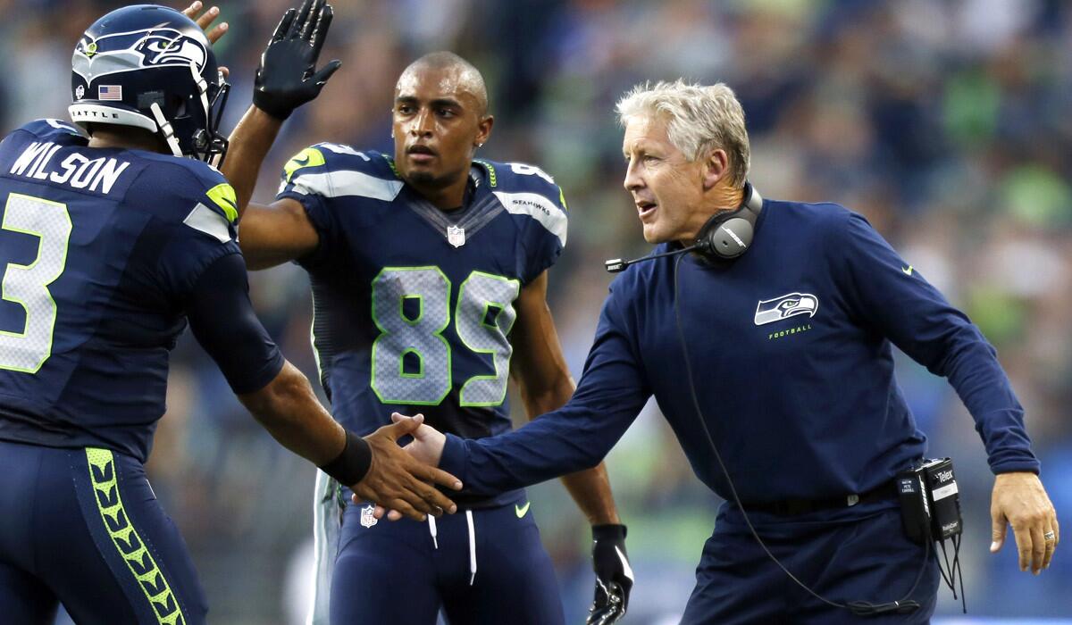 Seahawks Coach Pete Carroll, right, quarterback Russell Wilson (3) and wide receiver Doug Baldwin (89) will try to do something that hasn't been done in a decade: repeat as NFL champions.