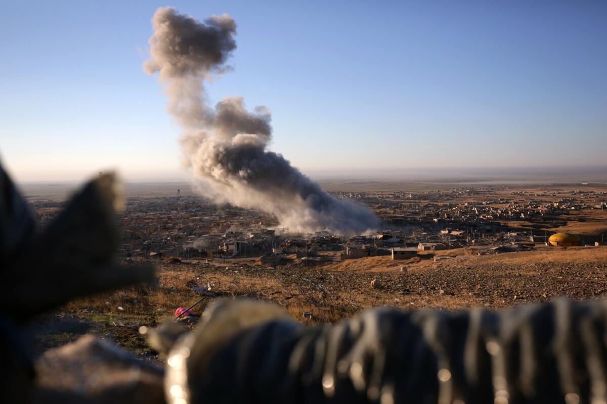Smoke believed to be from an airstrike rises from the northern Iraqi town of Sinjar on Nov. 12.