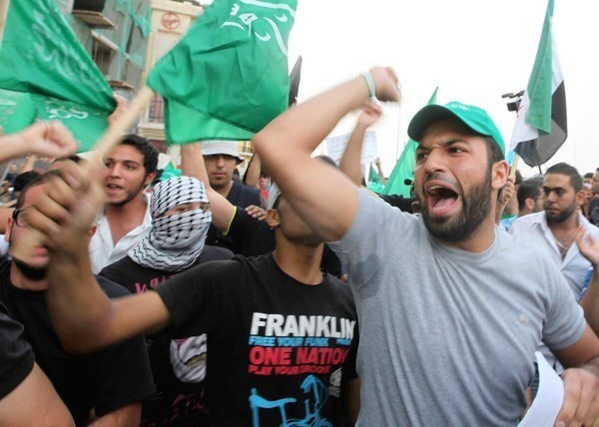 Demonstrators chant slogans Oct. 20 in Martyrs Square in Beirut to protest the killing of Lebanon's intelligence chief, Gen. Wissam Hassan and seven others.