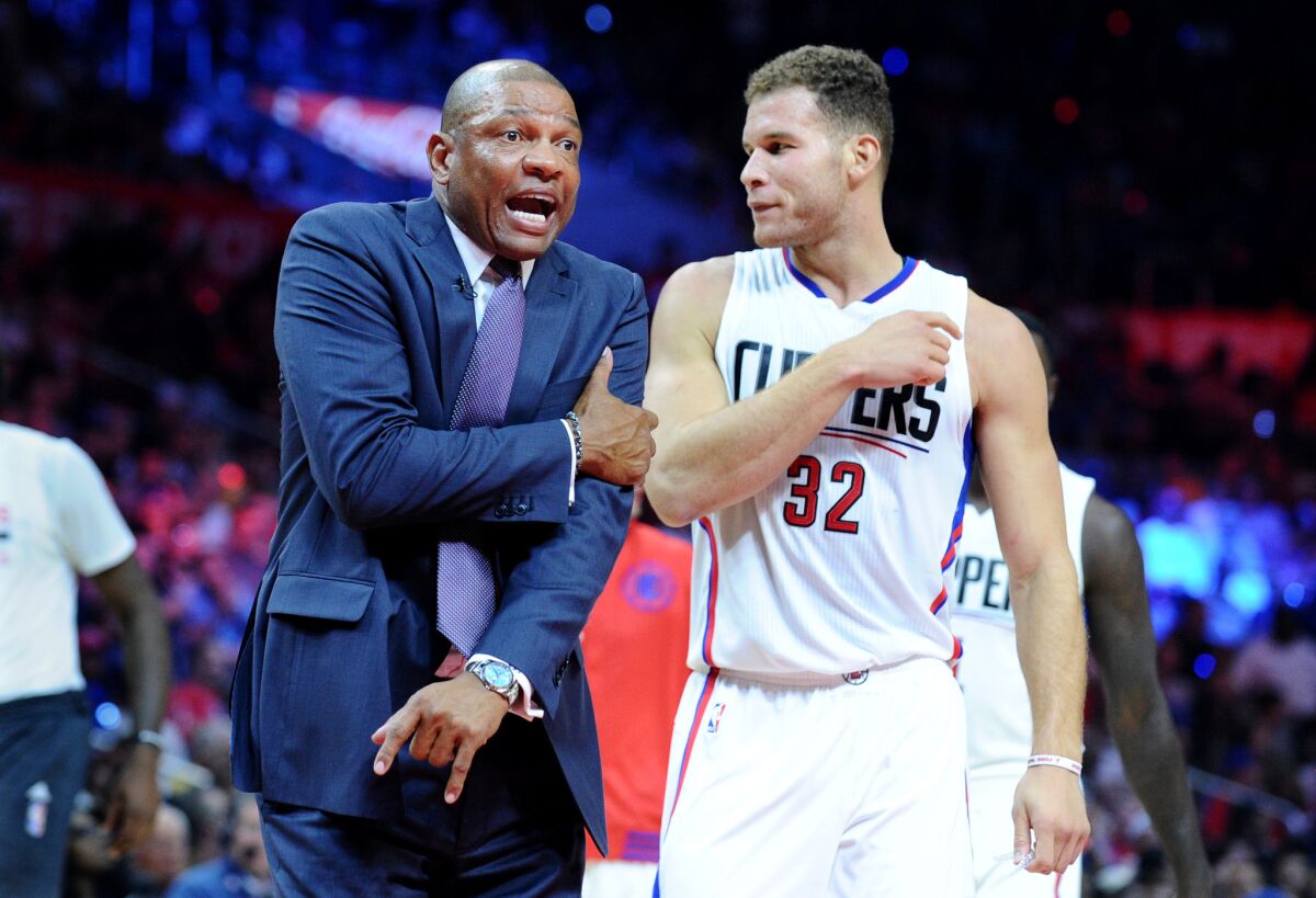 Clippers Coach Doc Rivers complains to a referee in front of Blake Griffin on Oct. 29.