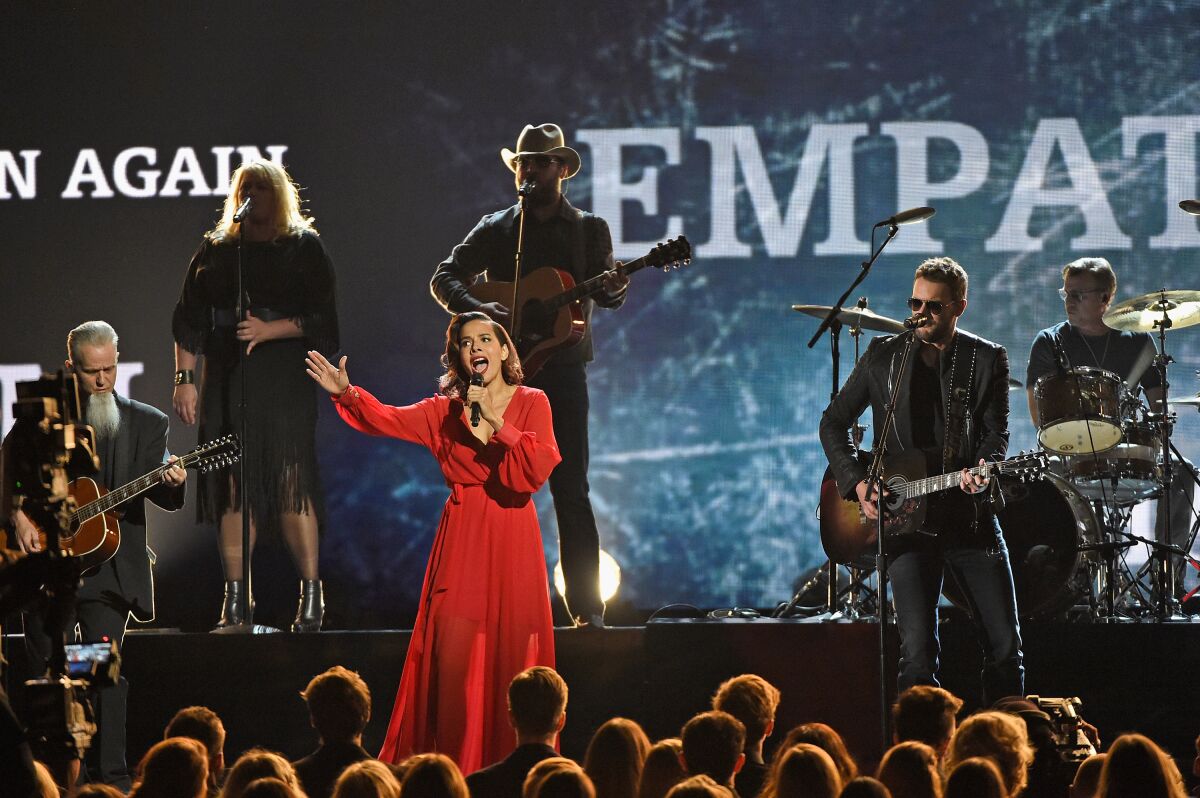 Rhiannon Giddens, Eric Church and other musicians onstage at the 2016 CMA Awards.