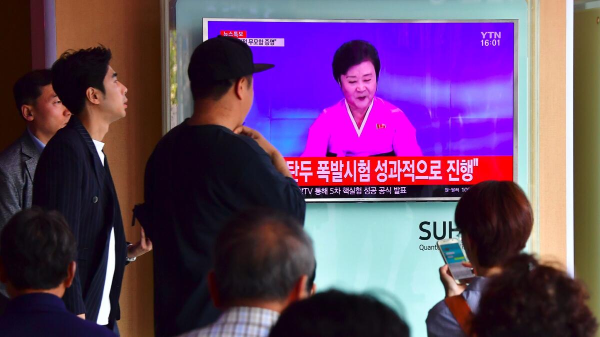 People at a railway station in Seoul watch a television news broadcast Sept. 9 showing a North Korean anchor announcing the country's latest nuclear test.