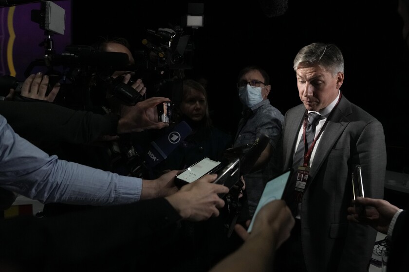 Russia delegate Alexey Sorokin, right, gestures as speaks to journalists end of the FIFA congress at the Doha Exhibition and Convention Center in Doha, Qatar, Thursday, March 31, 2022. (AP Photo/Hassan Ammar)
